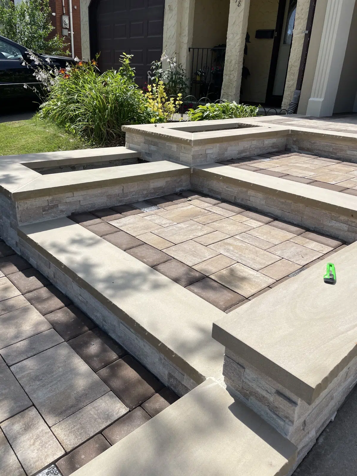 Tiered stone seating walls and paver patio in tan and brown tones — APPLE MASONRY INC in Brooklyn